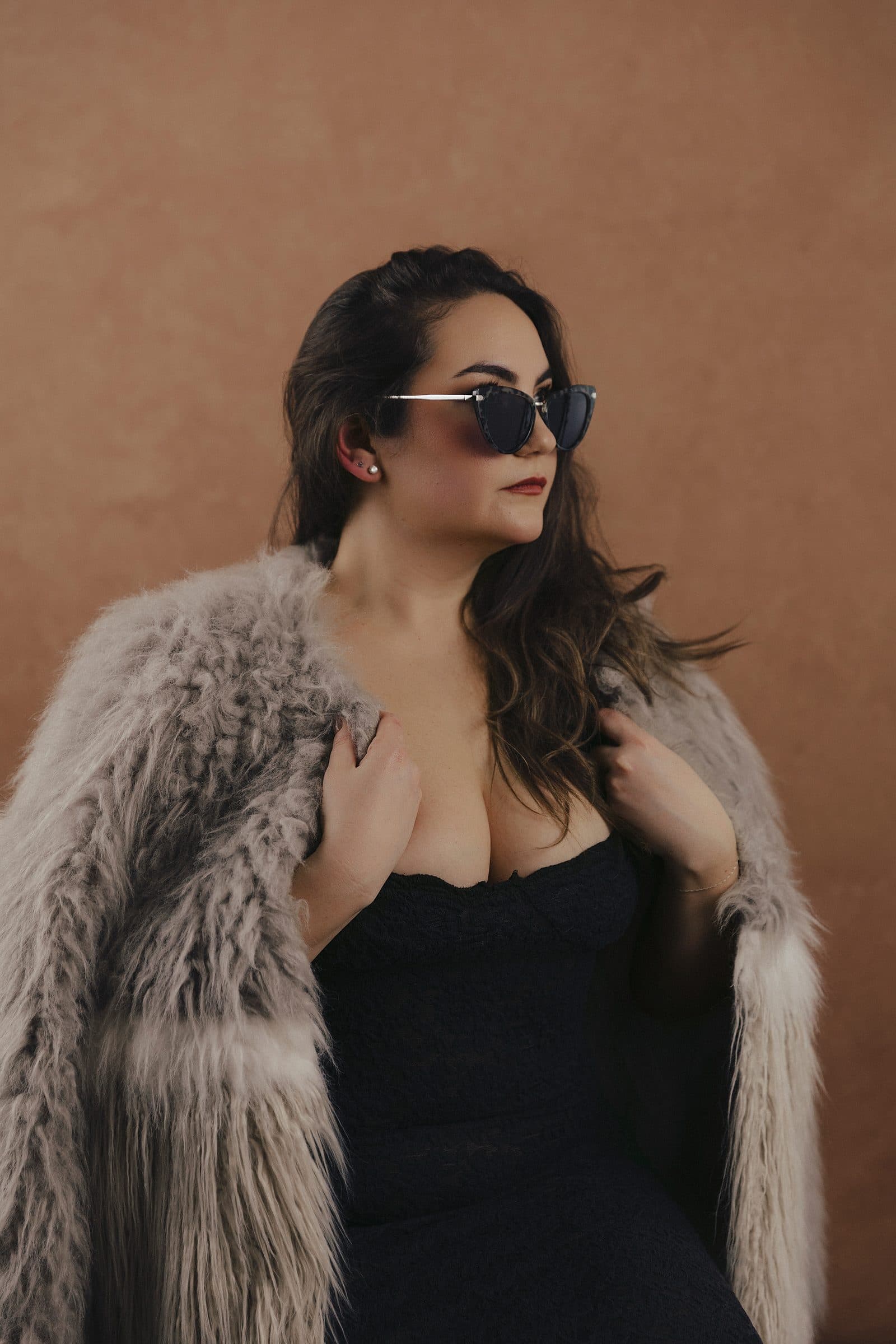 Woman in a fur coat and dark sunglasses as her look is styled at Body & Soul Studios.
