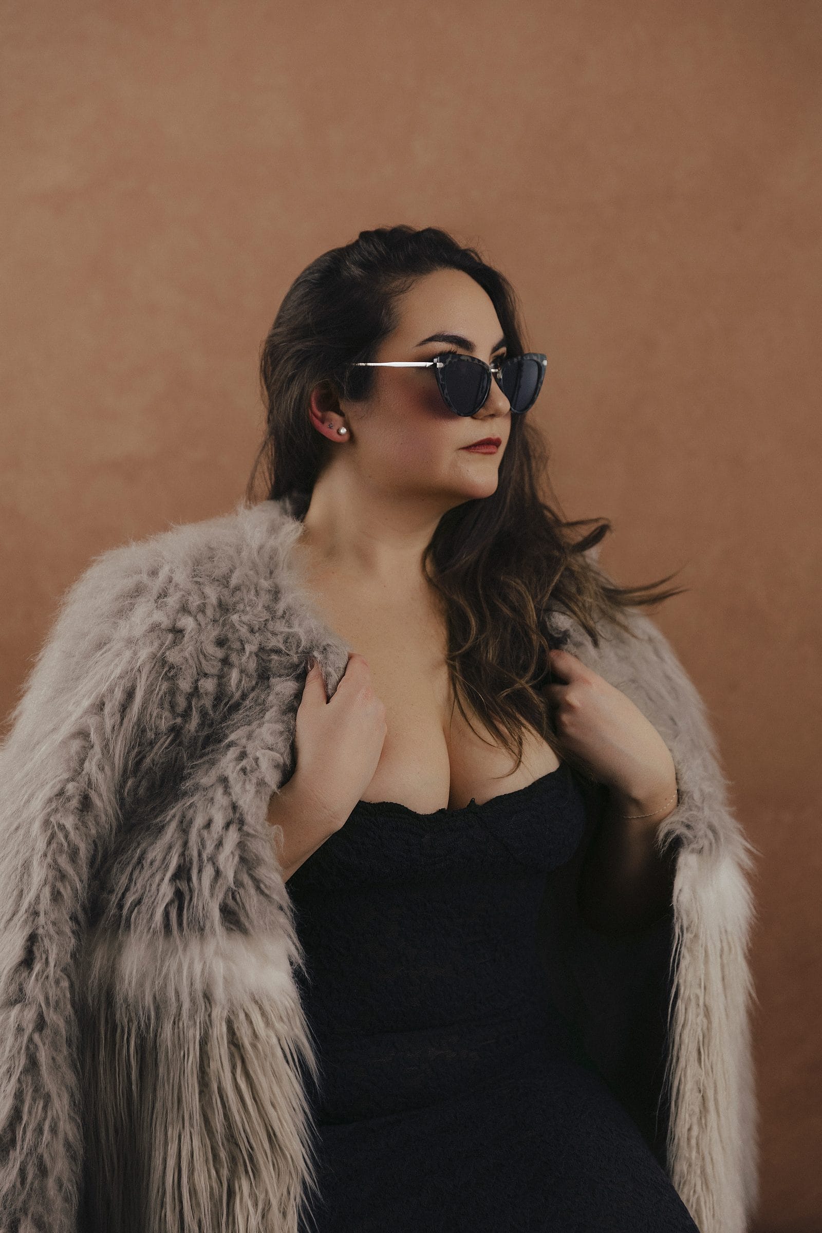 Woman in a fur coat and dark sunglasses as her look is styled at Body & Soul Studios.
