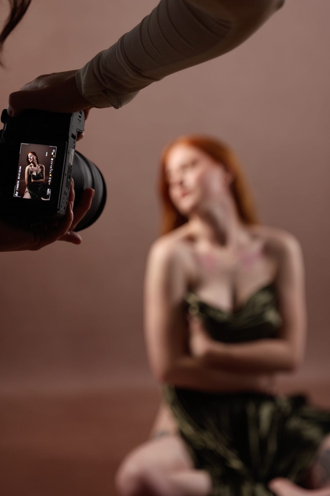 A photographer reviewing a frame on camera during a shoot at Body & Soul Studios.