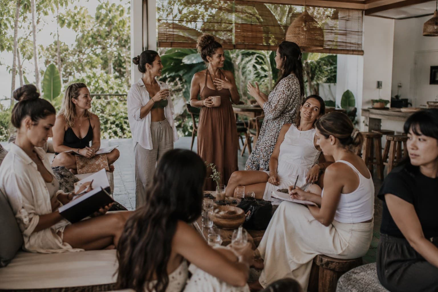 Women in conversation on a villa veranda in Bali, a Body & Soul wellness retreat.