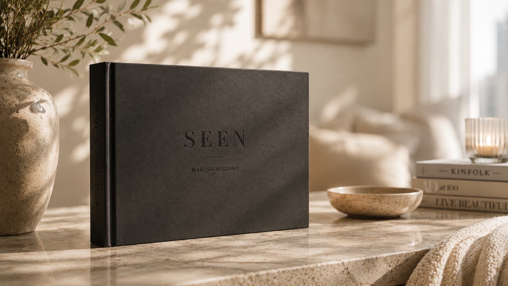 The SEEN fine-art book, Making History, resting on a marble table in soft daylight.